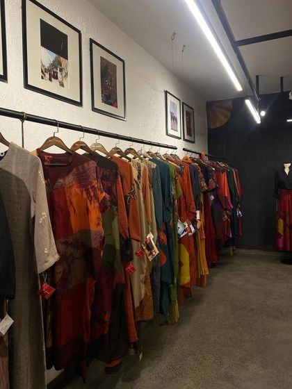 The clothing rack at Medha's new store, showcasing her collection of sustainable, handcrafted pieces. My events aim to tell the story behind the designs, focusing on elements like tie-dye and mindful production.