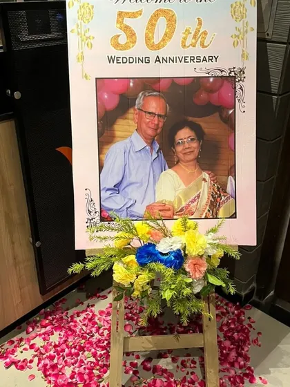 A personalized welcome easel for a 50th wedding anniversary, displaying a cherished photo of the couple.