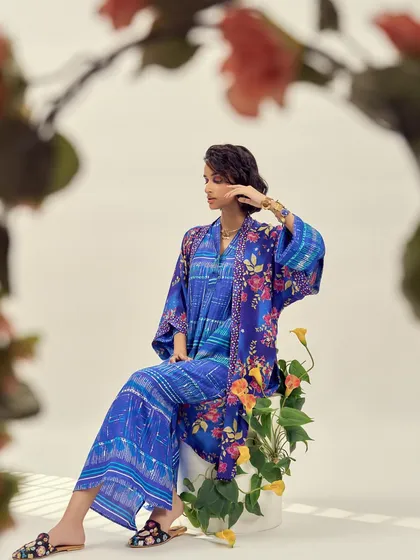 This look features a stunning blue printed kimono layered over a matching co-ord set. The styling creates a rich, textured, and high-fashion ethnic look.