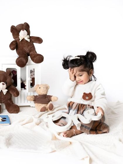 "Oops, I just turned ONE!" This playful shot with the teddy bears and the number one is a fun way to capture the personality of a newly minted one-year-old.