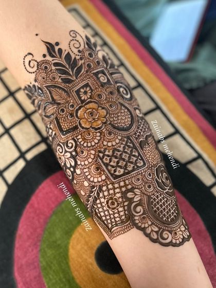 A beautiful bridal armband, showcasing a mix of floral, geometric, and net patterns.