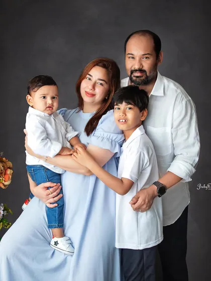 Better when we're together. This is a beautiful, classic family portrait against a dark backdrop, with everyone looking so happy.