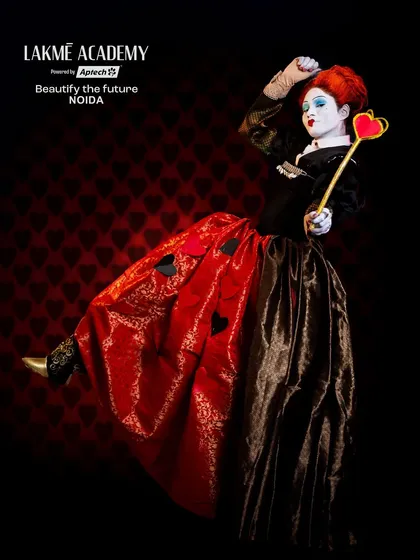 A fantasy look inspired by the Queen of Hearts. This full-length shot shows the dramatic costume and pose, bringing a classic character to life with a dark twist.