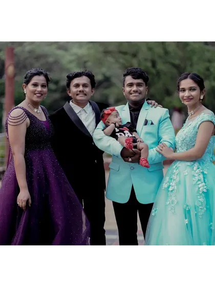 A wonderful group photo celebrating family bonds. This picture showcases two of my popular gowns, the purple beaded dress and the light blue ball gown, worn together for a large family portrait.