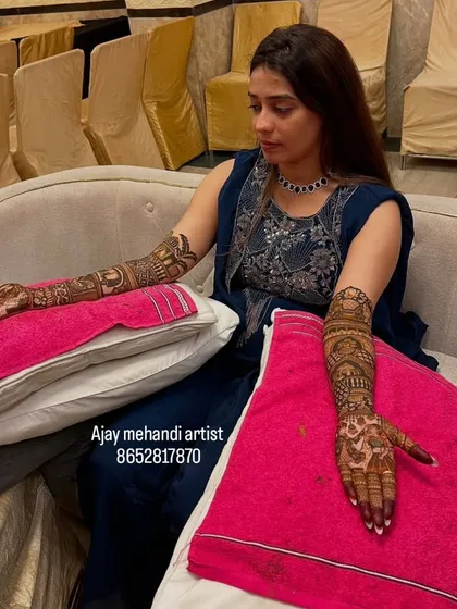 The bride patiently getting her full-arm mehndi done. I provide service at your home so you can be in your own comfort.