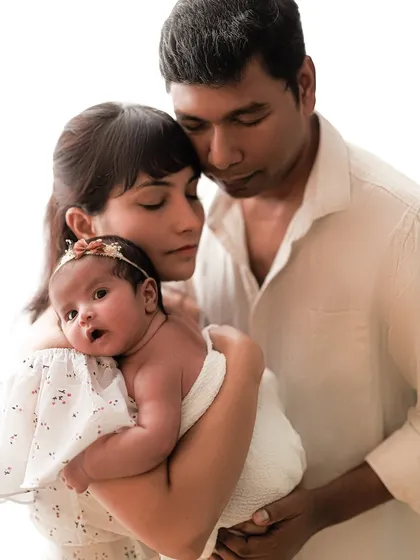 Tender hugs from both parents. I love how the baby is looking right at the camera, giving us a peek at her curious little personality.