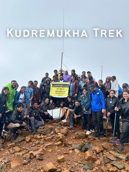 We made it. The entire group celebrating at the Kudremukha peak, a moment of shared victory.