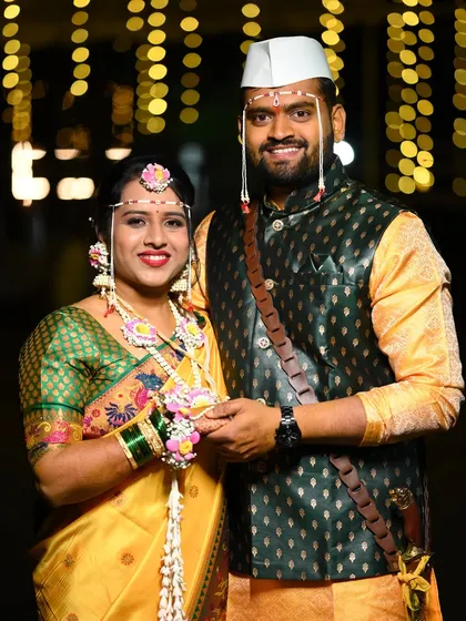 A happy moment between the soon-to-be-wed couple. The groom wears a traditional cap while the bride glows in her custom floral accessories.