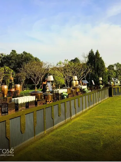 A wide-angle shot of our extensive buffet setup for a large outdoor event. This demonstrates our capacity to handle large-scale gatherings without compromising on luxury or elegance.