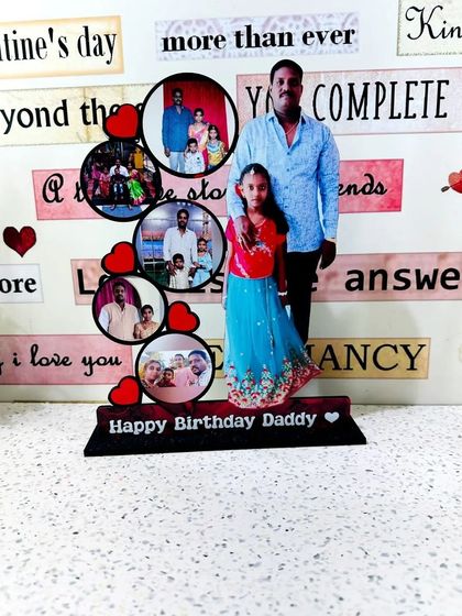 A custom tabletop frame for a 'Happy Birthday Daddy' gift. It combines a full-size cutout of the father and daughter with a collage of their memories together.