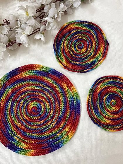 This set of three doilies shows a rainbow spiral pattern in different sizes. They can be used together for a layered look or separately around the house.