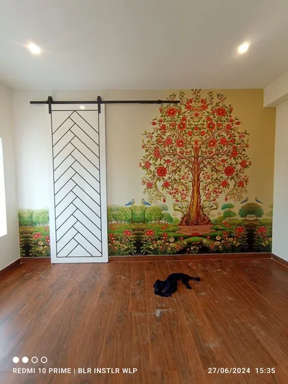 A custom mural featuring the 'Tree of Life' in a traditional Indian art style. This installation brings cultural elegance and a powerful visual story to the living space.