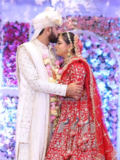 An embrace that says it all. The bride's makeup is flawless, ensuring she looks her best in these once-in-a-lifetime photos.