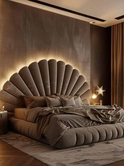 This luxury master bedroom features a stunning shell-shaped, velvet-tufted headboard with integrated backlighting. The entire bed frame is upholstered to match, creating a plush and opulent focal point.