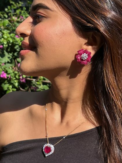 Ladies and gentlemen, her. A beautiful profile shot showcasing our ruby floret earring, a piece designed to radiate confidence and style.