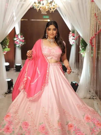A full view of this pretty in pink engagement look. The soft makeup and romantic curls are perfect for a celebration of love.