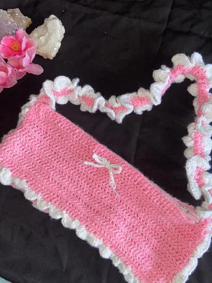 Another angle of the pink ruffle bag, showing how the strap is shaped. It's soft and comfortable on the shoulder.