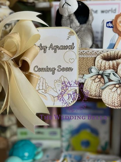 "Baby Agrawal Coming Soon." We love creating personalized announcement tags to make our baby hampers even more special.