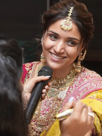 The model smiling as I explain the design I am creating on her hand.