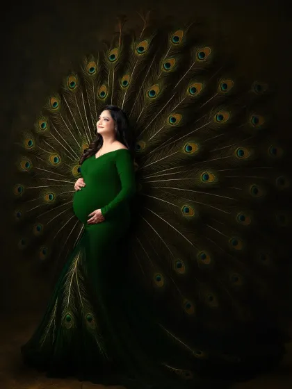 We believe motherhood is a majestic journey. This portrait, featuring an expectant mother in a custom green gown with a dramatic peacock feather train, is one of our signature artistic concepts. We use creative props and lighting to craft powerful, unforgettable images that celebrate this special time.