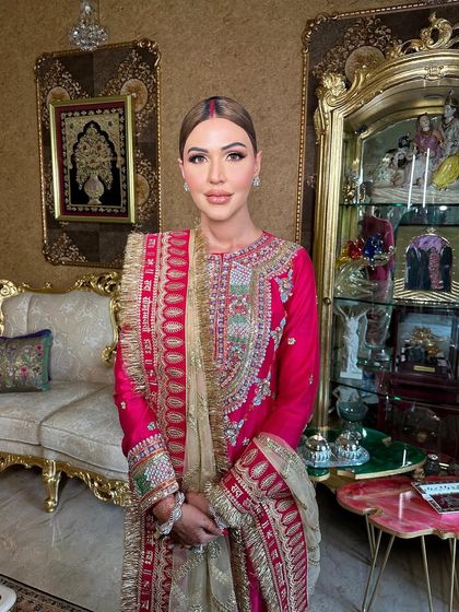 The client looking serene and elegant, her hair pulled back into a clean, center-parted style before being braided.