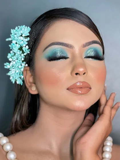 This pose highlights the blend of the eyeshadow and the seamless transition from the deep blue to the lighter shimmer. We spend a lot of time on blending techniques in my course.