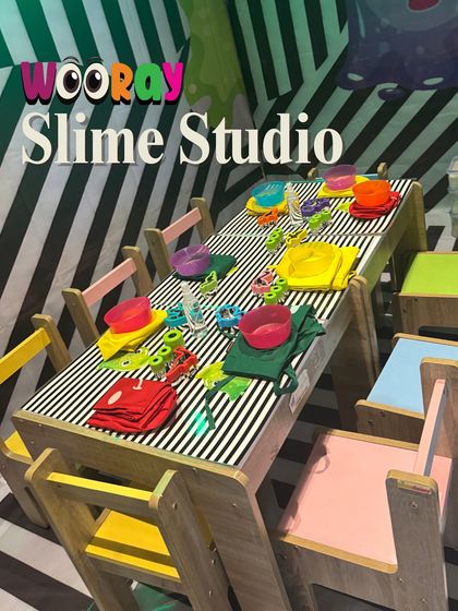 A look inside our vibrant and colorful Slime Studio. With its fun striped decor and individual creation stations, it's the perfect setting for a gooey and creative adventure.