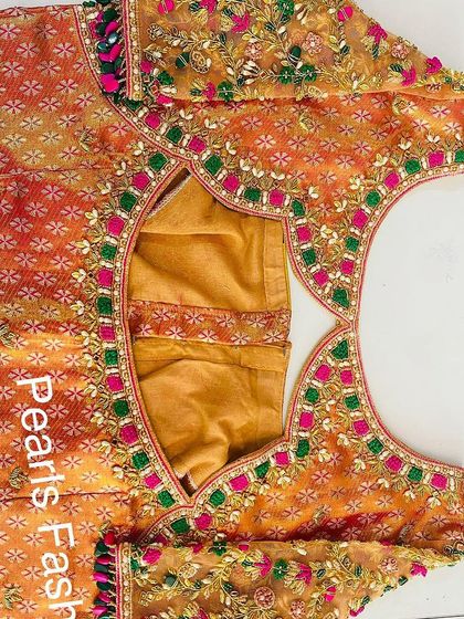 This is the back of the blouse shown earlier (ID 5). It has a unique cutout shape, and the heavy embroidery continues all around for a complete look.