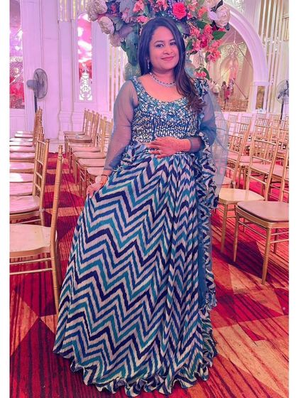 This client looks wonderful in the blue chevron-print lehenga. It's a great example of how you can wear a trendy, high-fashion look for your event by renting.