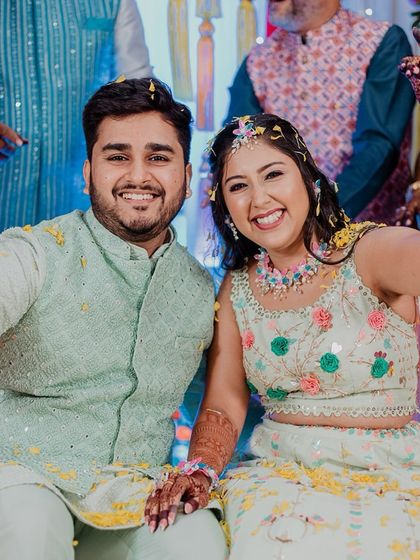 A happy selfie-style portrait of the couple, capturing their smiles up close during the Haldi.