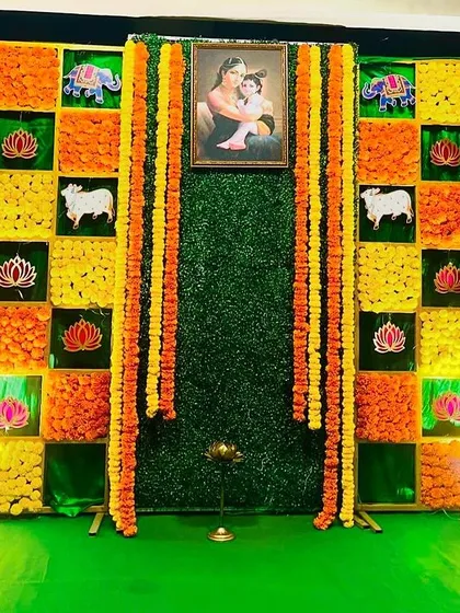 The Sreemantham decoration featuring the checkerboard flower wall, a design that brings together bright colors and traditional symbols.