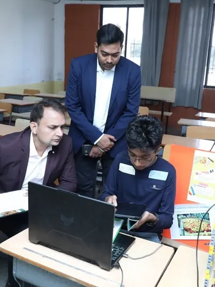 Our founder and an instructor review a student's project. We believe that while traditional education is important, the ability to create and innovate is what truly sets kids apart.