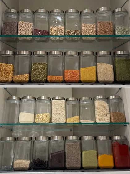 A complete four-shelf pantry system, showcasing everything from whole pulses and dals to flours and spices. This is the ultimate goal for a functional and beautiful Indian pantry.