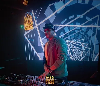 As a VDJ, I mix visuals live with the music to create a fully immersive experience. Here you can see the custom graphics projected on the large screen behind me, adding another layer to my Bollywood and Punjabi sets.