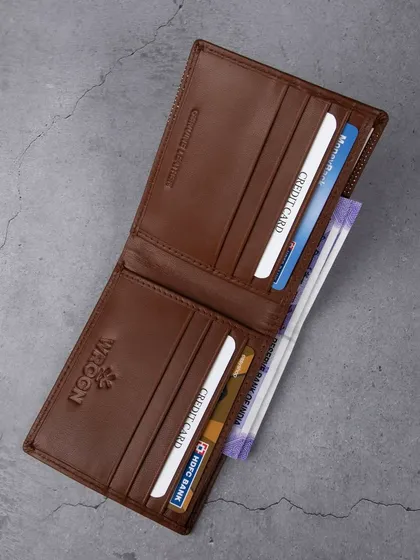 An open view of the dotted 'WROGN' wallet, showing its interior.