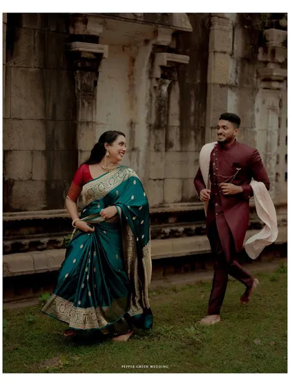 A candid moment of laughter and movement, as the couple enjoys their pre-wedding shoot amidst the historic grounds of a Thanjavur temple.
