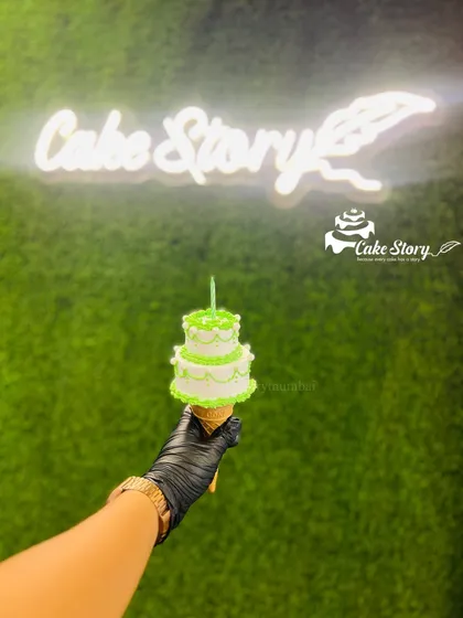 My trending cone cake. This fun and unique design features a mini two-tier cake served on top of an ice cream cone, perfect for a quirky celebration.