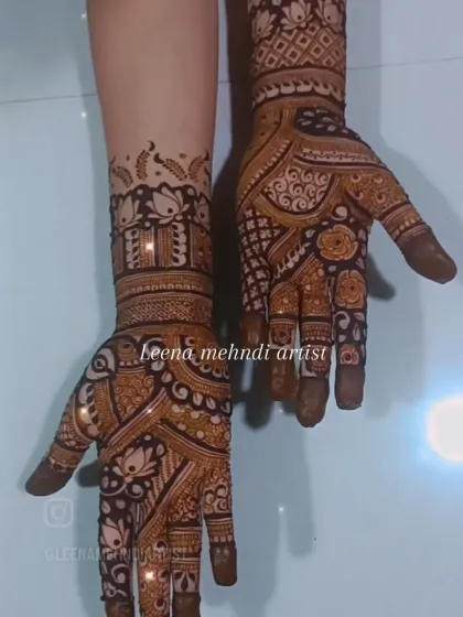 This design showcases a beautiful blend of modern and traditional styles. The bold, dark-filled areas contrast with the delicate line work, featuring lotus motifs and geometric bands.