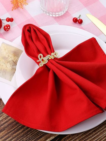 Here are the "Love" napkin rings styled with a bold red napkin. This pairing creates a classic, passionate look, perfect for Valentine's Day, weddings, or any declaration of love.