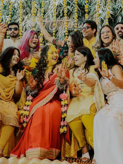 A moment of pure celebration with the whole family. The bride and her loved ones cheer and laugh together during the haldi, creating a memory filled with energy and love.