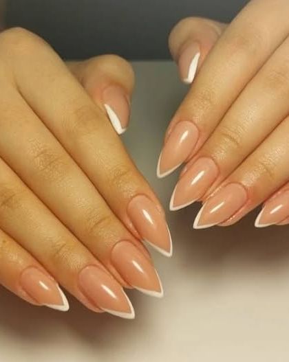 A sharp and elegant V-French manicure on long, stiletto-shaped nails for a dramatic and modern look.