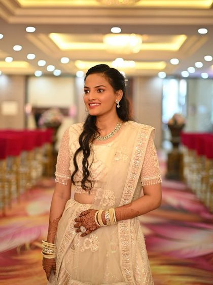 A candid shot of a client looking radiant in an elegant white lehenga. It’s perfect for a reception or a sangeet ceremony.