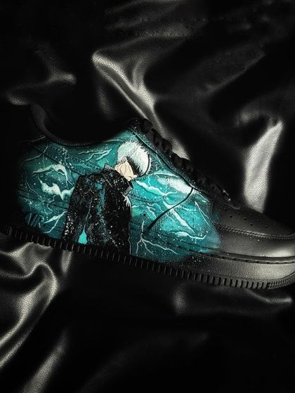 A custom black Nike Air Force 1 featuring Satoru Gojo from Jujutsu Kaisen surrounded by his Cursed Technique Reversal: Red.