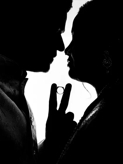A creative silhouette shot from an engagement ceremony. I use techniques like this to create unique, artistic images that symbolize the couple's union, focusing on the ring that marks their promise.