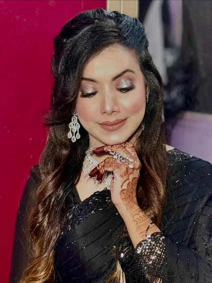 The client showing off her intricate henna design along with her soft glam makeup.