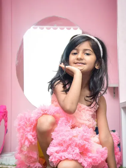 A pretty-in-pink princess posing from inside our dollhouse-style play structure.
