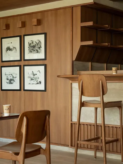 A detail of the bar and art-lined wall.