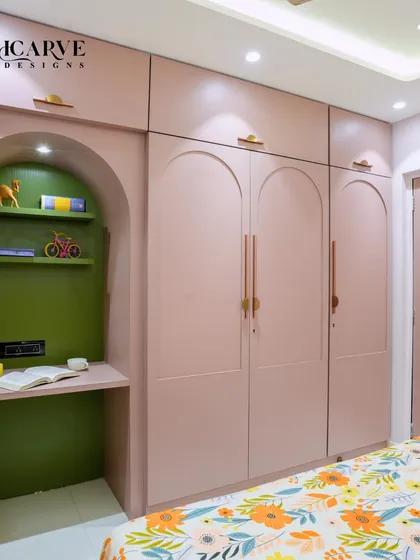 This shot showcases the floor-to-ceiling wardrobe with a built-in study nook, demonstrating our expertise in creating multi-functional spaces.