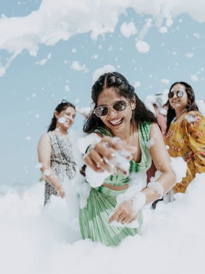 A joyful bride having the time of her life in a fun-filled foam party.