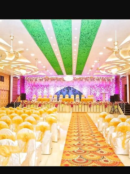 A view from the back of Akshata banquet hall, showing the long aisle and the impressive scale of the stage decoration.